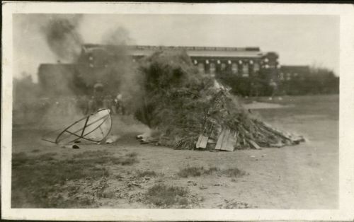Photograph of a large freshman beanie replica burning in the bonfire during the Moving Up Ceremony, 1926. University Photograph Collection box 1702.