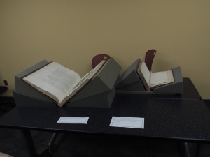 Two of our rare books propped up in book cradles (Photo b Rachel Seale)