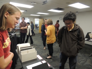 Collections Archivist, Laura Sullivan, talking to student about oldest book in the library and a Civil War diary from Van Zandt Family Papers