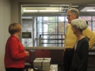 Reference Specialist Becky Jordan discussing artifacts with Life Members of the ISU Alumni Association Andrea and Doug Van Houweling, (Andrea, 1965, chemical technology and Doug, 1965, government). Andrea is the daughter of William Robert Parks, the 11th president of ISU and for whom Parks Library is named