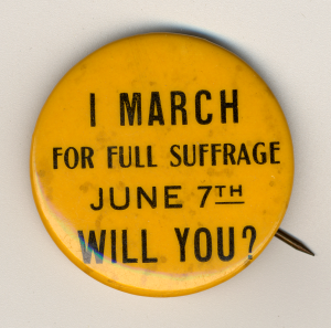 Yellow political button with dark text that says "June 7th, I march for full suffrage will you?"