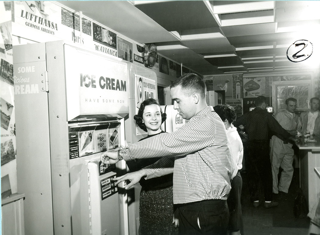 Student getting an ice cream treat from a vending machine in the Hub in 1960.