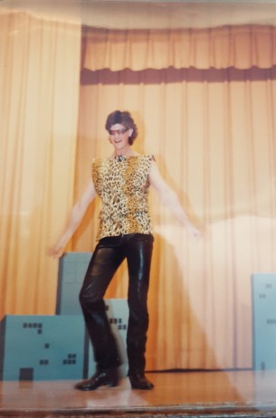 Male student in cheetah print vest and leather pants.