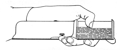 Line drawing of a left hand holding a metal tool that acts as a shelf on which lines of metal types are stacked.